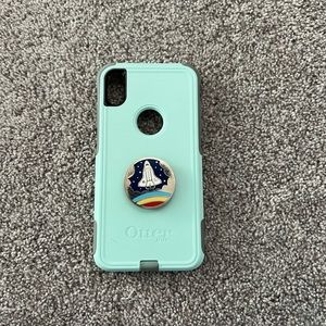 Teal Otterbox case with pop socket attached for IPhone Xs MAX